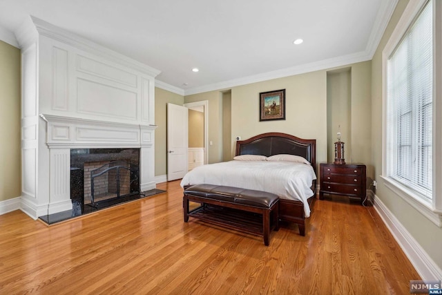 bedroom with light hardwood / wood-style floors and ornamental molding