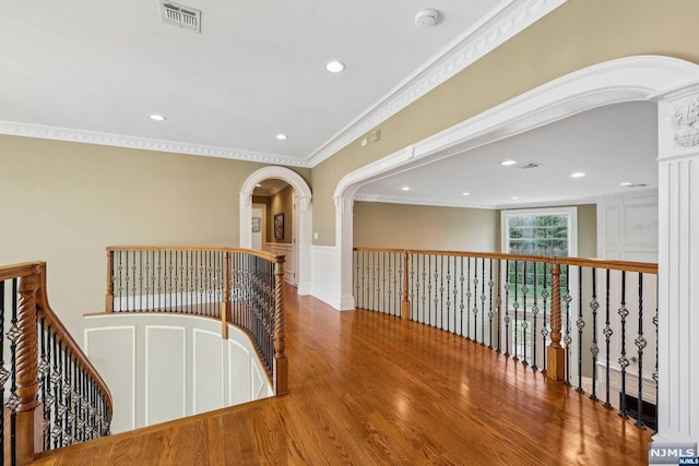 corridor featuring ornamental molding and hardwood / wood-style flooring