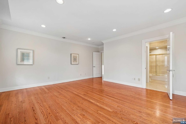 empty room featuring light hardwood / wood-style floors and ornamental molding