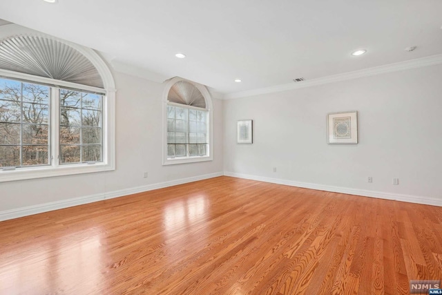 unfurnished room featuring crown molding and light wood-type flooring