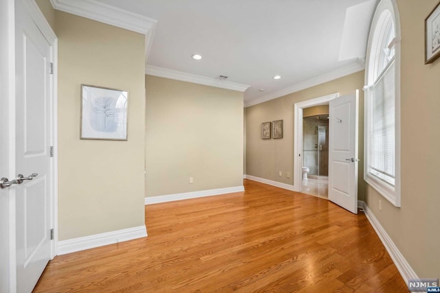 unfurnished room with light wood-type flooring and ornamental molding