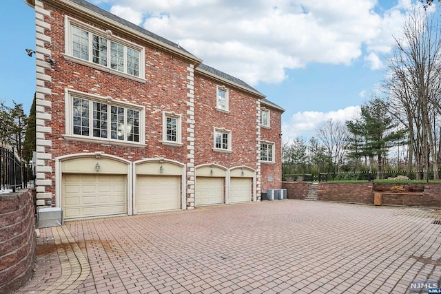 view of home's exterior featuring cooling unit and a garage