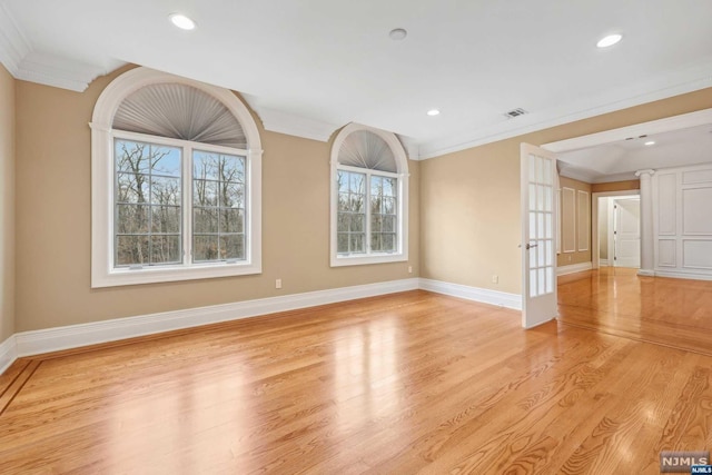 unfurnished living room featuring light hardwood / wood-style flooring, french doors, and ornamental molding