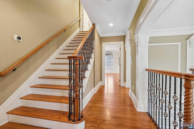 stairway featuring hardwood / wood-style flooring and ornamental molding