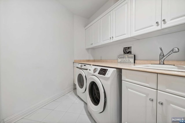 laundry room featuring cabinets, independent washer and dryer, sink, and light tile patterned floors