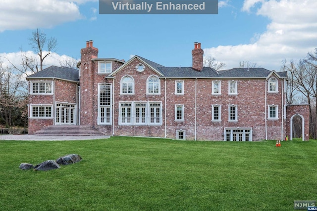 rear view of house with a lawn and french doors