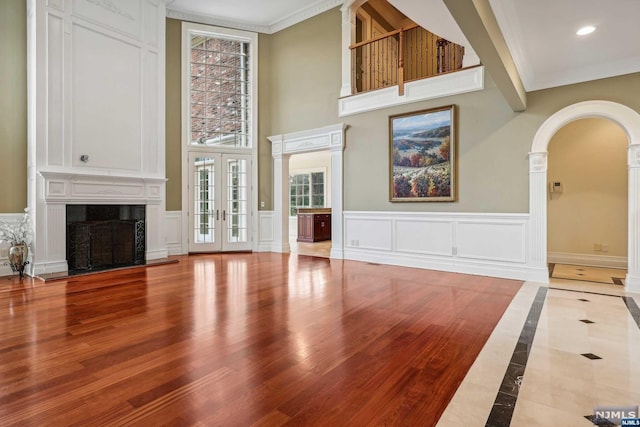 living room featuring hardwood / wood-style flooring, ornamental molding, and french doors