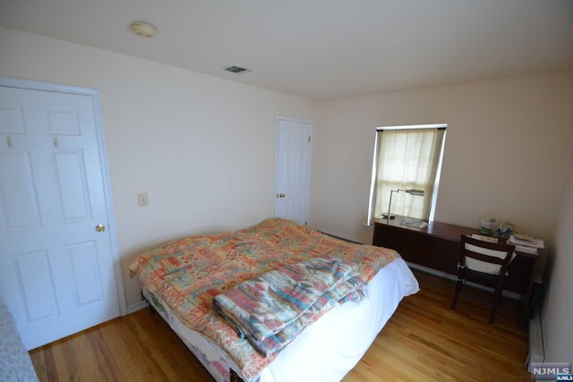 bedroom featuring wood-type flooring