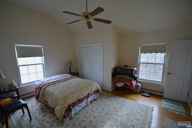 bedroom with a closet, light hardwood / wood-style floors, multiple windows, and ceiling fan