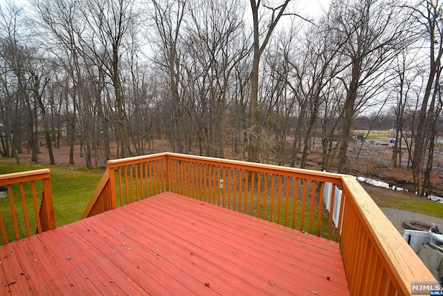 wooden terrace with a lawn