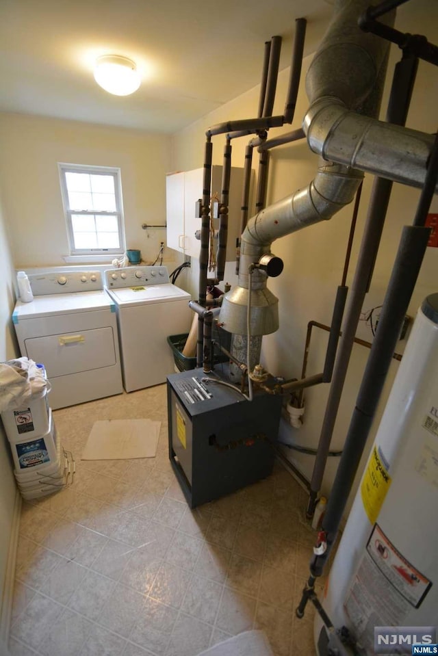 laundry area featuring gas water heater, light tile patterned floors, and washing machine and clothes dryer