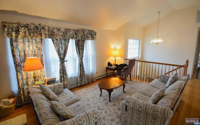 living room with hardwood / wood-style floors, lofted ceiling, and a baseboard radiator