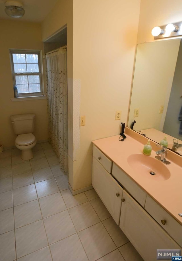 bathroom featuring tile patterned flooring, vanity, toilet, and a shower with curtain