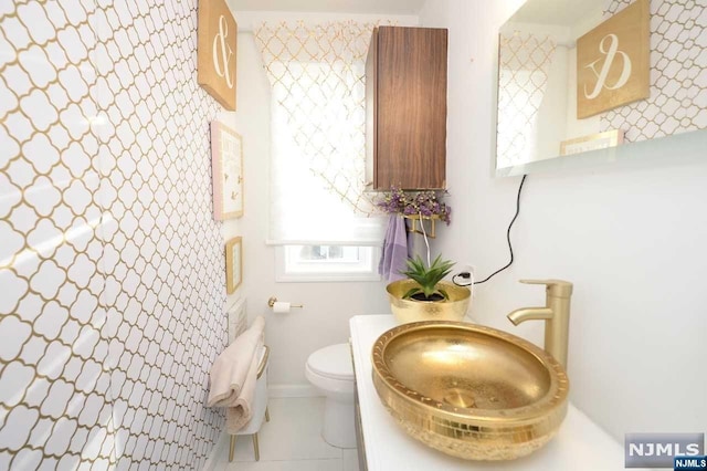 bathroom featuring tile patterned floors, toilet, and sink