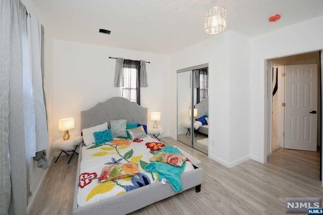 bedroom featuring light hardwood / wood-style floors and a closet