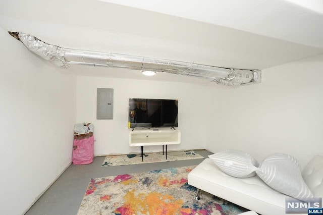 living room featuring electric panel and concrete floors