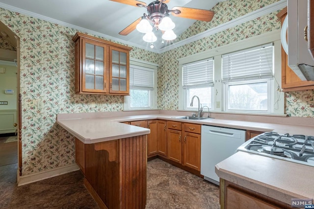 kitchen featuring dishwasher, crown molding, sink, ceiling fan, and kitchen peninsula