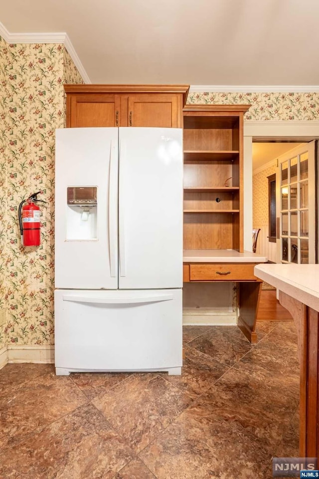 kitchen with white refrigerator with ice dispenser and ornamental molding