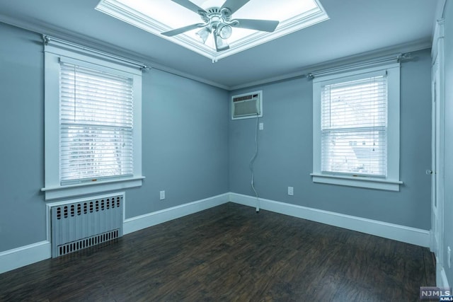 unfurnished room featuring a wall mounted air conditioner, a wealth of natural light, dark wood-type flooring, and radiator