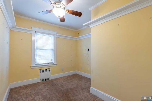 carpeted empty room featuring radiator, ceiling fan, and ornamental molding