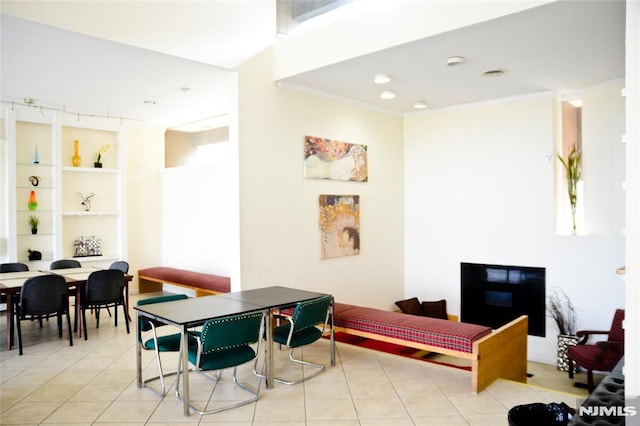 tiled dining area featuring ornamental molding