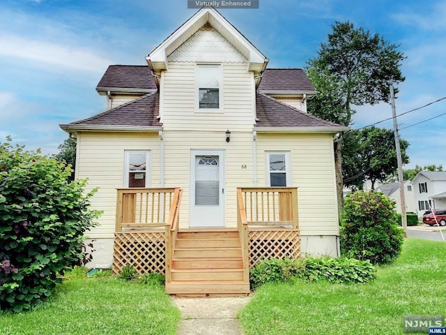 rear view of house featuring a yard