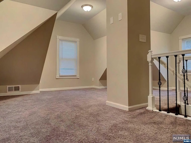 bonus room with carpet and vaulted ceiling