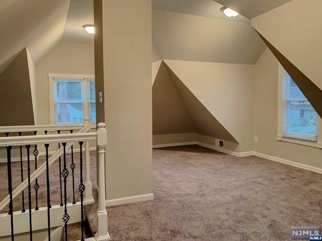 bonus room with carpet flooring and lofted ceiling