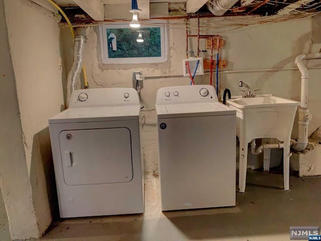 laundry room with separate washer and dryer and sink