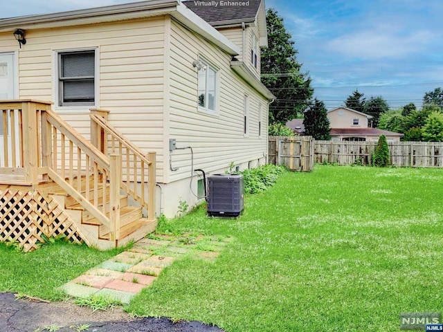 view of home's exterior with a lawn and cooling unit