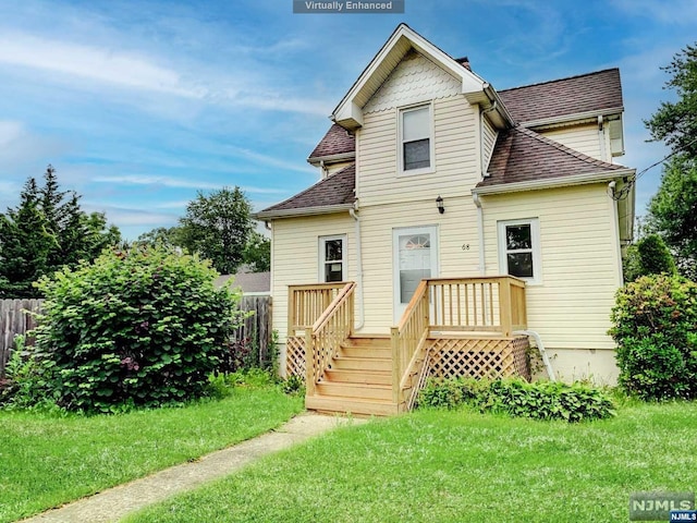 rear view of house featuring a lawn