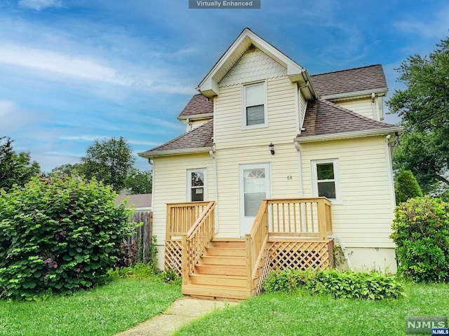 rear view of house featuring a yard