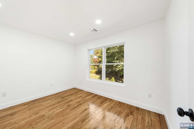 empty room with light hardwood / wood-style floors