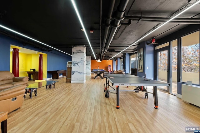 recreation room with wood-type flooring