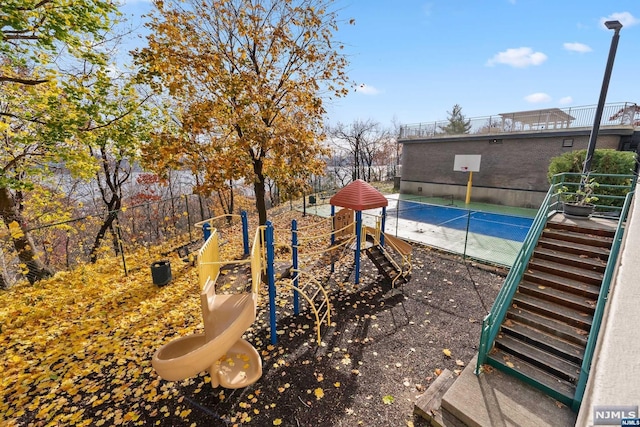 view of playground with tennis court