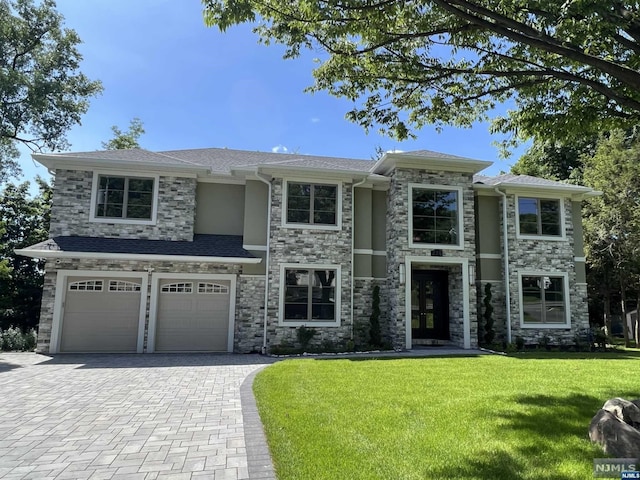 view of front of house with a front lawn and a garage