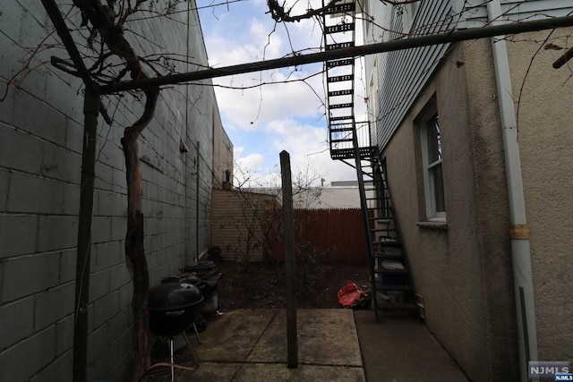 view of side of property with a patio area