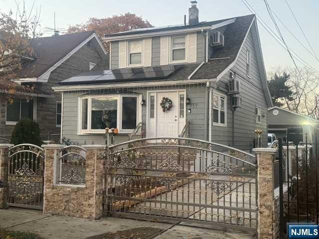 view of front of property featuring solar panels