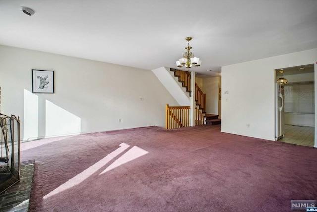 unfurnished living room with dark colored carpet and a chandelier