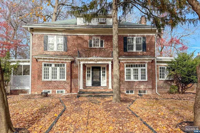 view of front of property featuring a sunroom