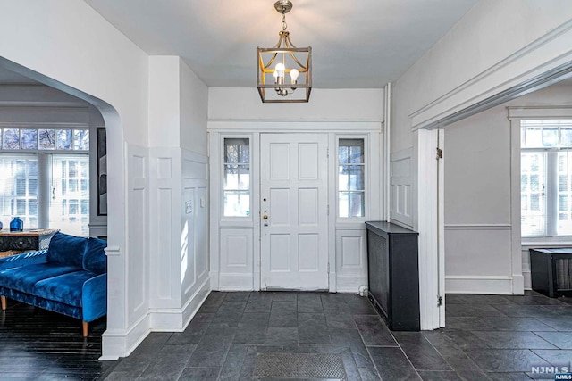 foyer featuring plenty of natural light and an inviting chandelier