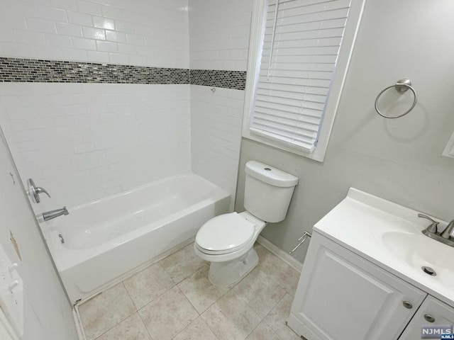 full bathroom with tile patterned floors, vanity, toilet, and tiled shower / bath combo