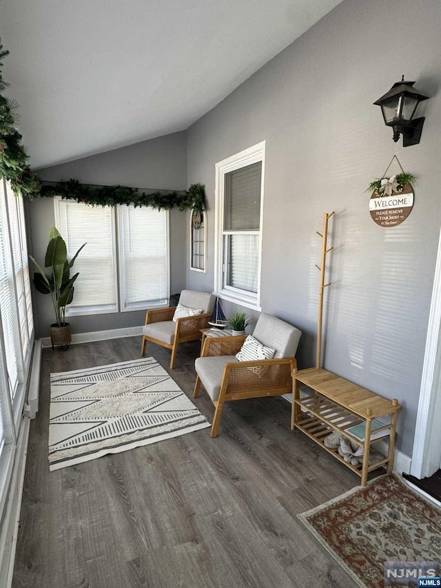 sunroom with a healthy amount of sunlight and vaulted ceiling