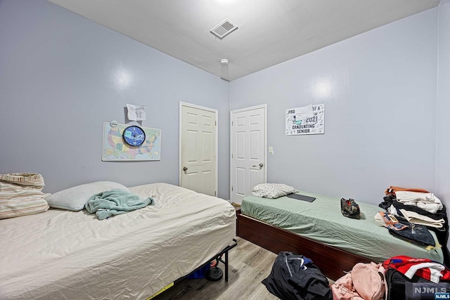 bedroom with light hardwood / wood-style floors