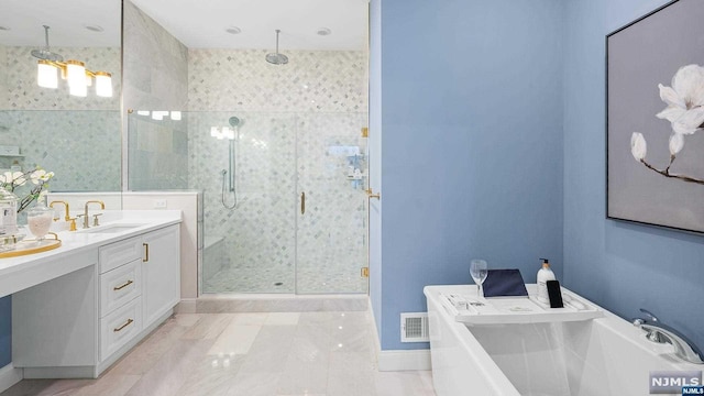 bathroom featuring vanity and separate shower and tub