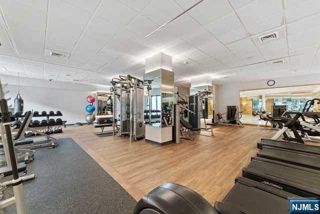 gym featuring visible vents and wood finished floors