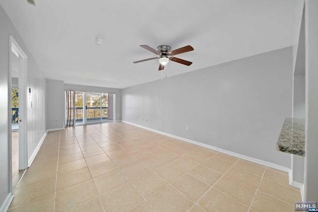 tiled empty room with ceiling fan