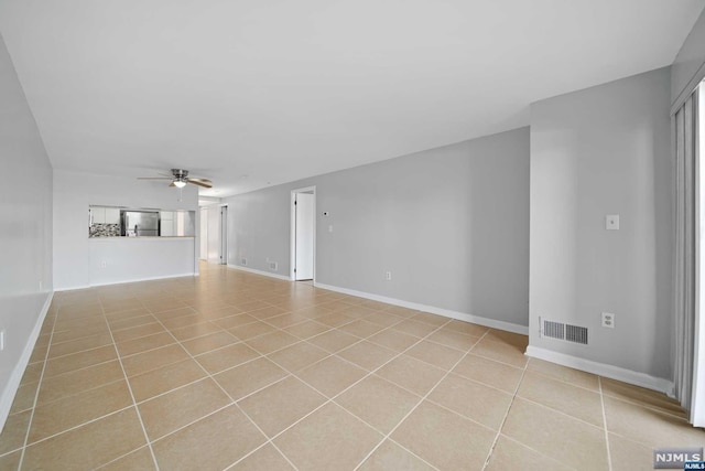 tiled empty room with ceiling fan