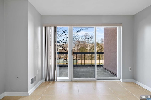 entryway with light tile patterned floors