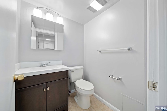 bathroom featuring tile patterned floors, vanity, and toilet